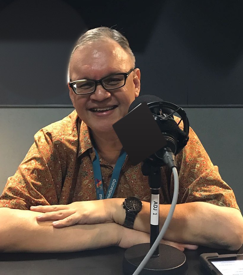 Ian Poulier, Singapore counsellor and English tutor, smiling at a radio studio microphone